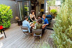 Group of people enjoying a meal on their deck built by Bayville deck builders